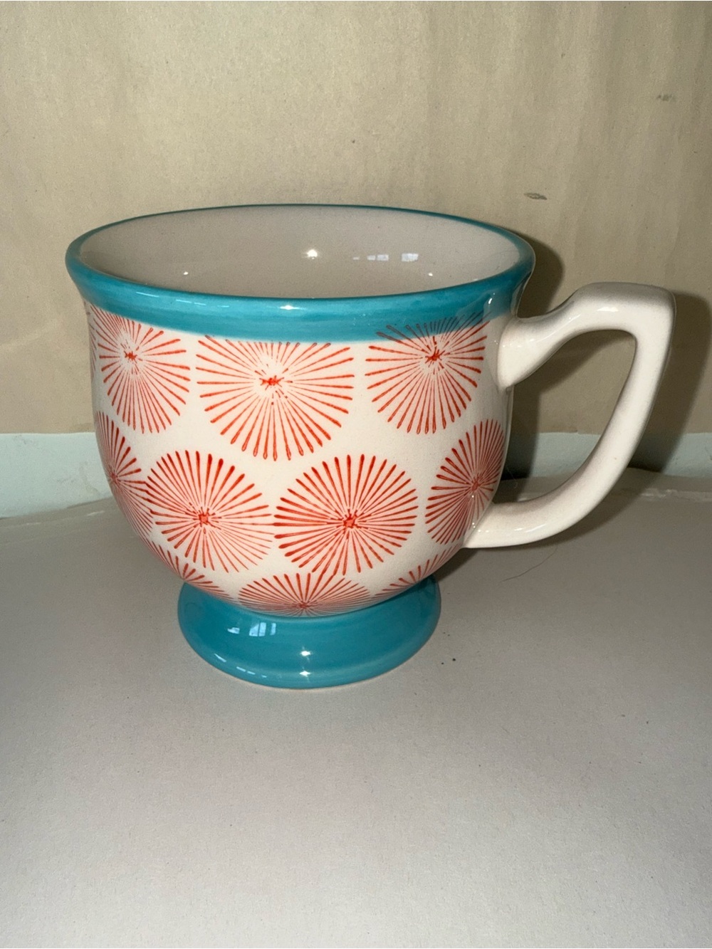Pedestal Mug with Turquoise Trim and Coral Burst Design